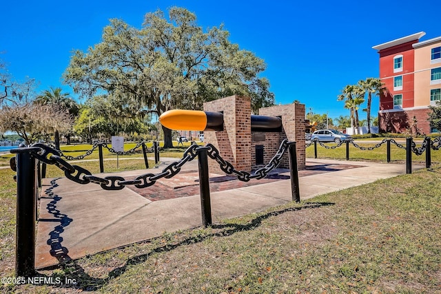 view of jungle gym featuring a lawn