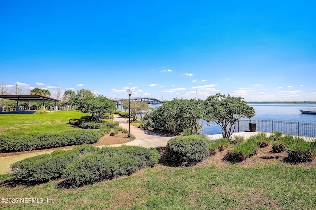 view of community with a water view, a gazebo, and a lawn