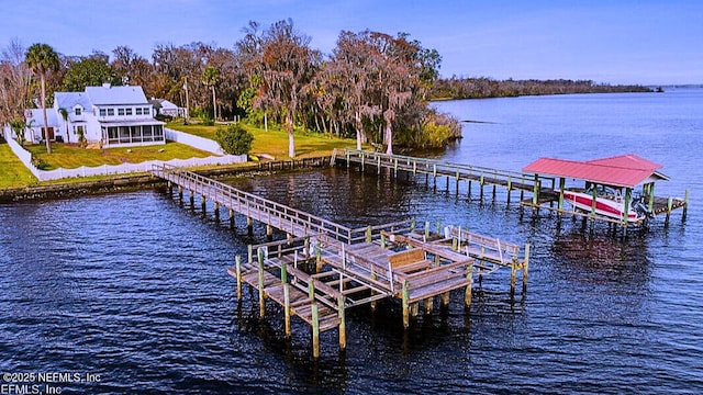 view of dock featuring a water view, a yard, and boat lift