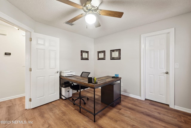 office with a textured ceiling, ceiling fan, and hardwood / wood-style flooring