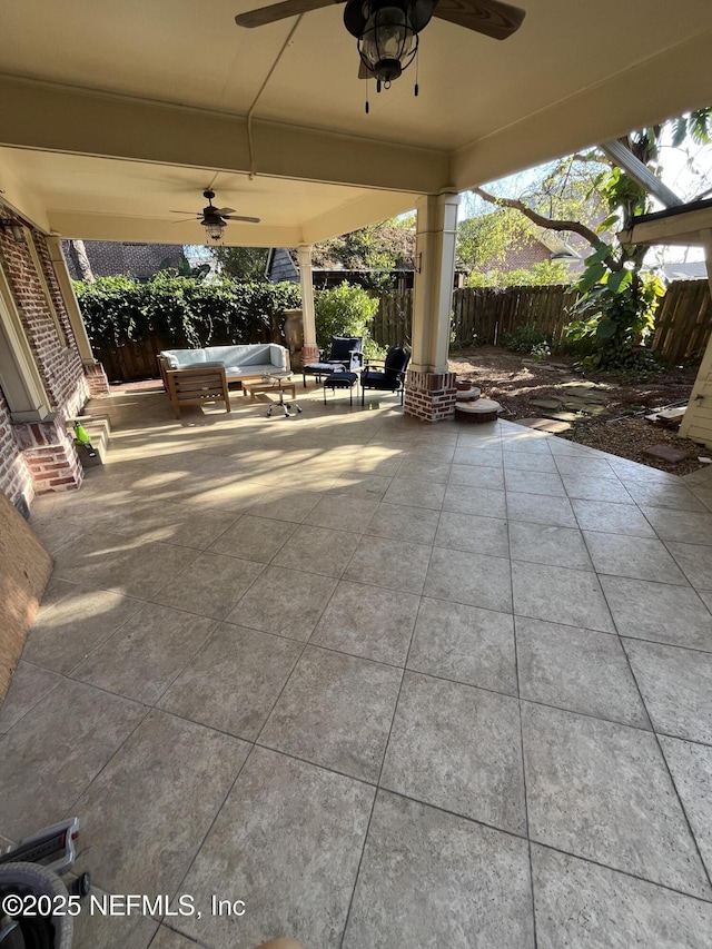 view of patio / terrace with ceiling fan, fence, and an outdoor hangout area