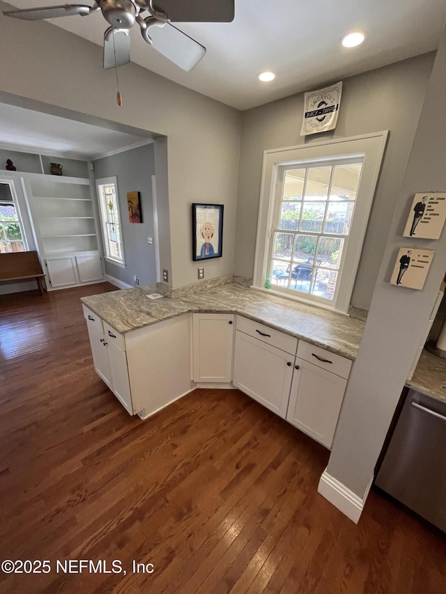 kitchen featuring dark wood-type flooring, white cabinetry, plenty of natural light, and light stone countertops