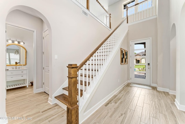 entrance foyer with a high ceiling and light wood-type flooring