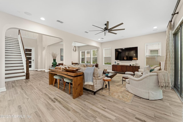 living room with ceiling fan and light hardwood / wood-style floors