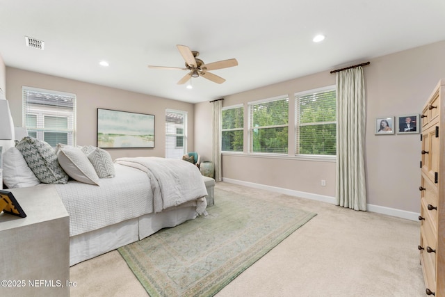 carpeted bedroom featuring ceiling fan and multiple windows