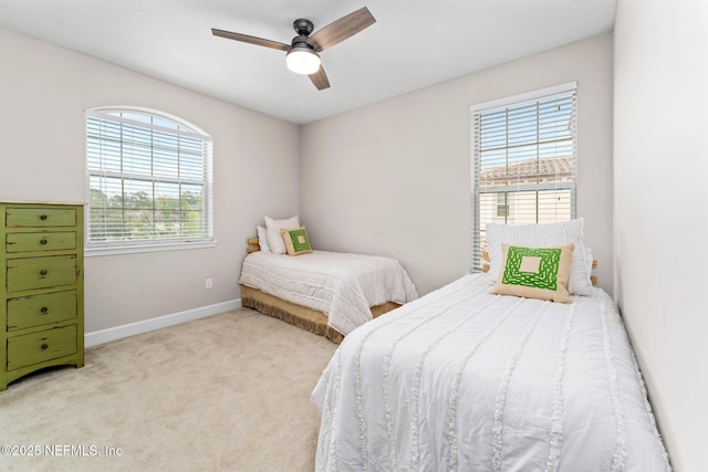 bedroom featuring ceiling fan and light carpet