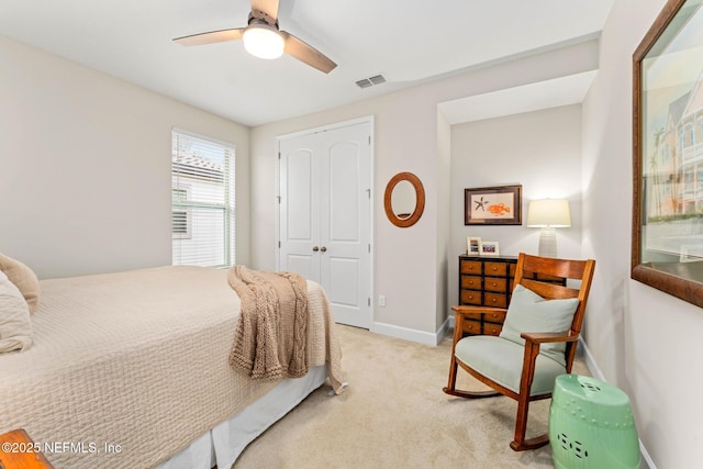 bedroom featuring ceiling fan, a closet, and light carpet