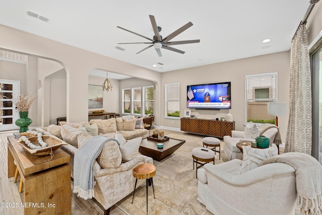 living room with light hardwood / wood-style floors and ceiling fan