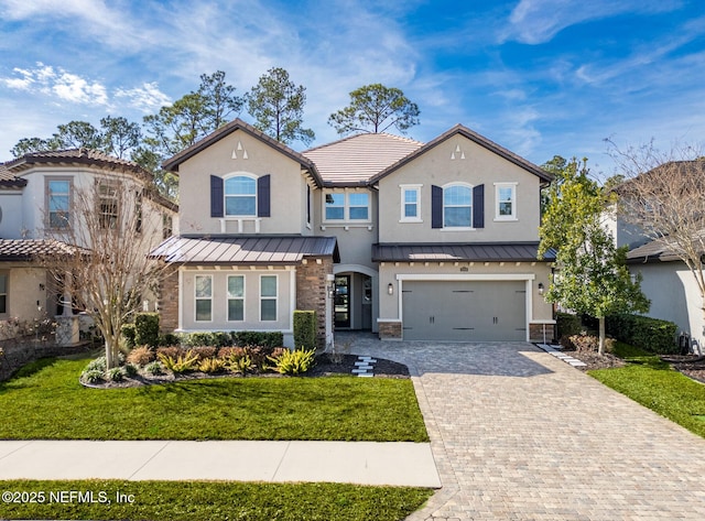 view of front of house with a garage and a front lawn