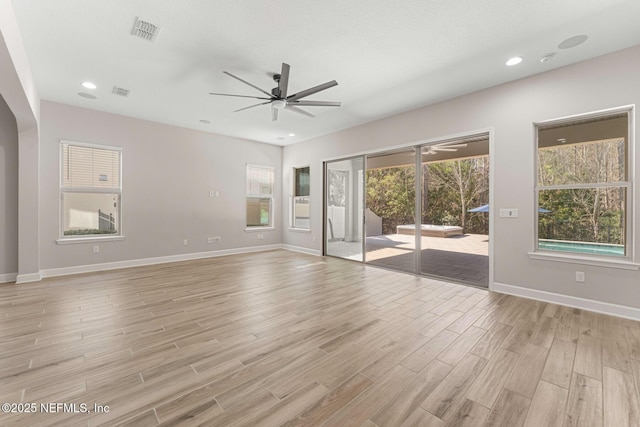 spare room featuring ceiling fan, a textured ceiling, and light wood-type flooring