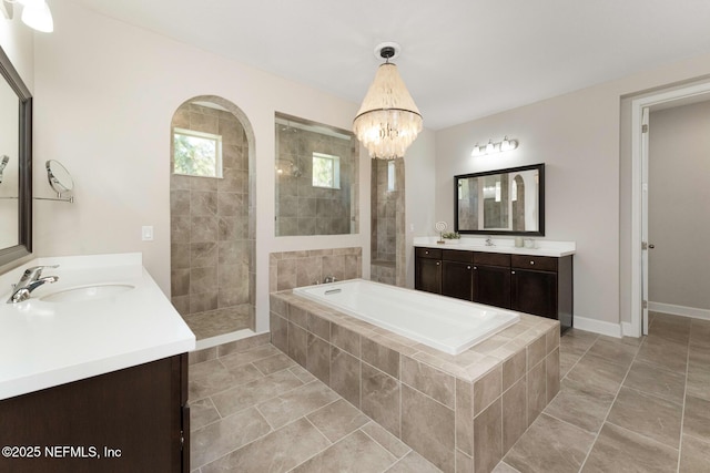 bathroom with vanity, tile patterned floors, shower with separate bathtub, and an inviting chandelier