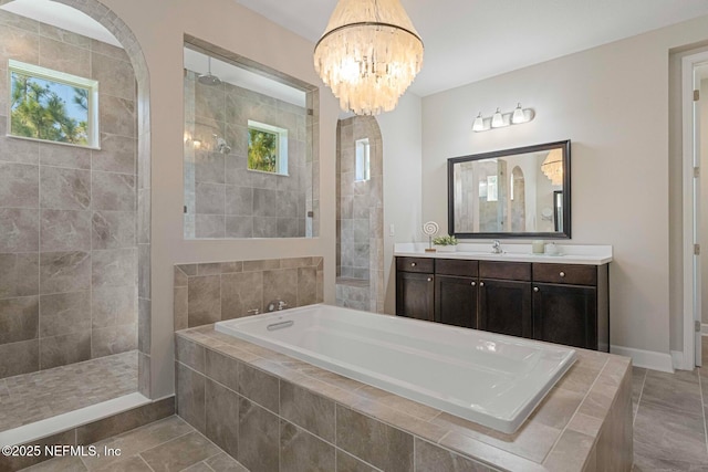 bathroom featuring vanity, a notable chandelier, tile patterned floors, and separate shower and tub