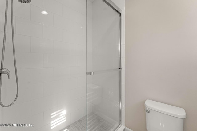 bathroom with walk in shower and toilet