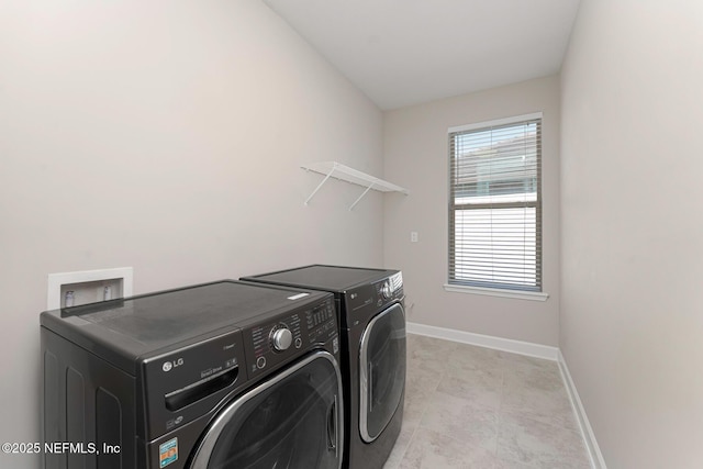 washroom featuring washer and clothes dryer