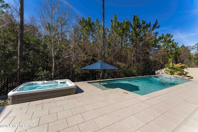 view of swimming pool featuring an outdoor hot tub and a patio area