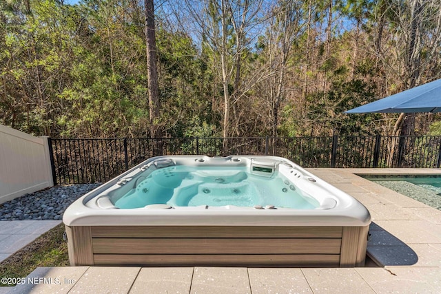 view of swimming pool with an outdoor hot tub