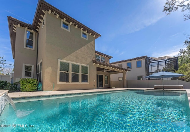 view of pool with a patio, pool water feature, and a lanai