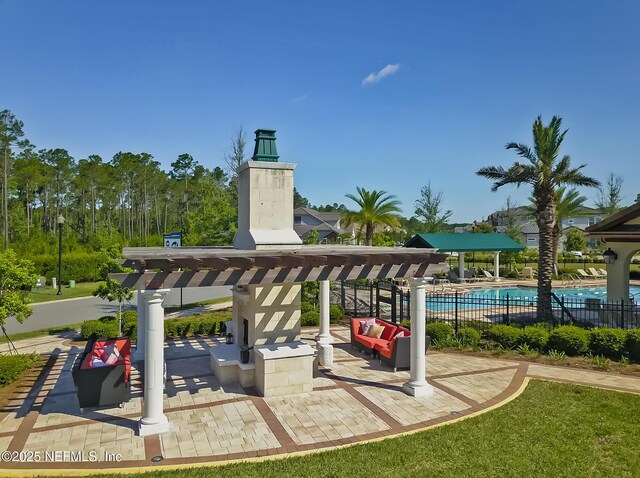 surrounding community with a pool, outdoor lounge area, and a patio