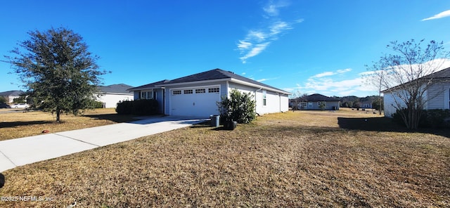 view of side of home with a garage and a lawn