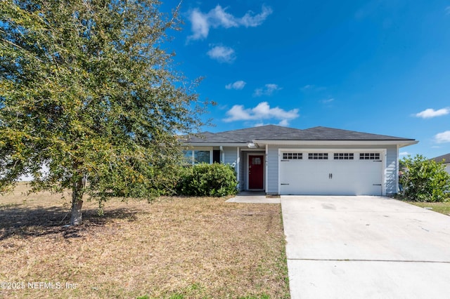 view of front of home with a garage and a front yard