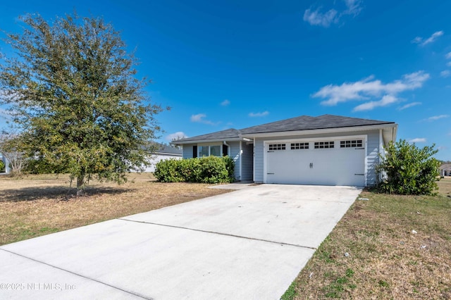 ranch-style house with a front lawn, an attached garage, and driveway