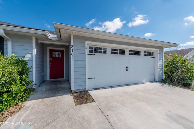 exterior space with driveway and an attached garage