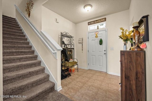 foyer entrance with a textured ceiling