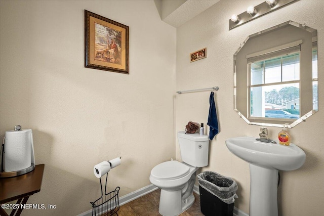 bathroom with toilet and tile patterned flooring