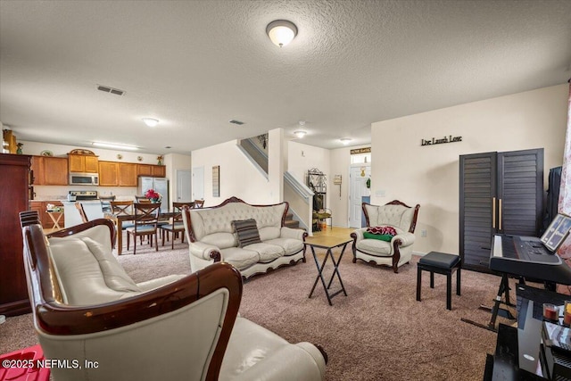 living room with a textured ceiling and light carpet