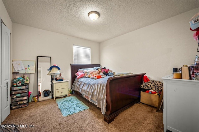 bedroom featuring a textured ceiling and carpet floors