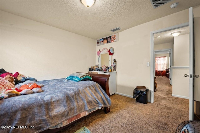 bedroom featuring a textured ceiling and carpet floors