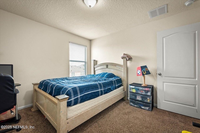 bedroom featuring a textured ceiling and carpet flooring