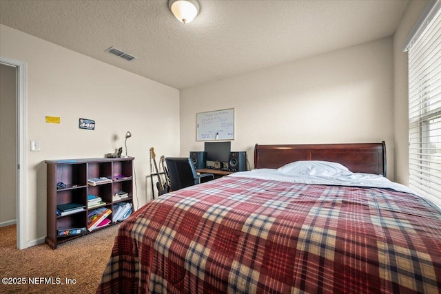 bedroom with carpet and a textured ceiling