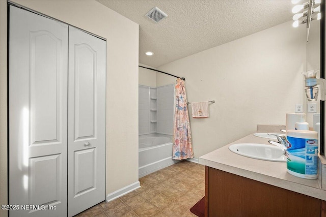 bathroom with vanity, a textured ceiling, and shower / tub combo with curtain