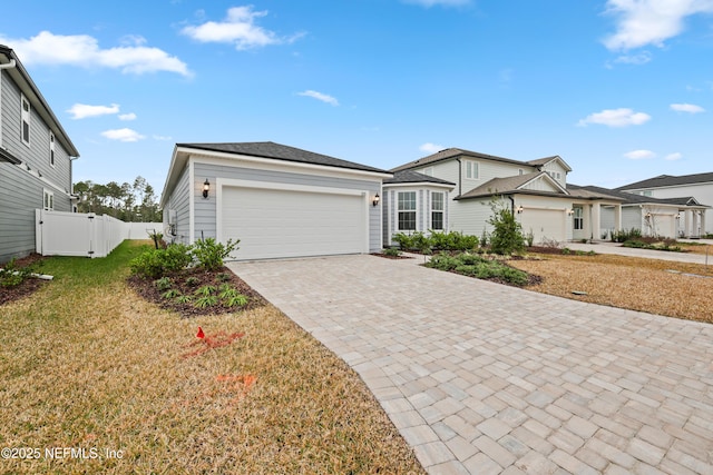 ranch-style house with a garage and a front lawn