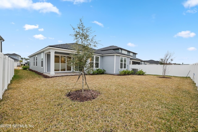 back of house with a lawn