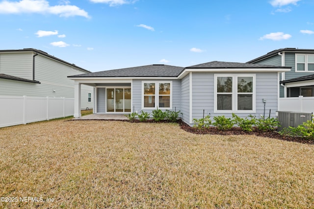 rear view of property featuring a yard and a patio