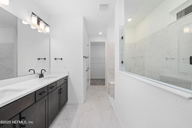 bathroom with vanity and tiled shower