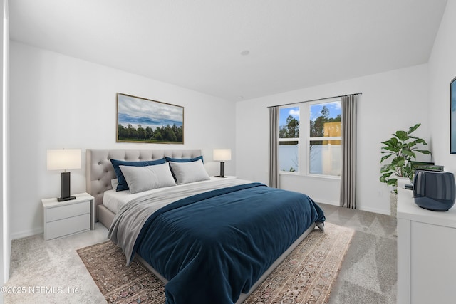 bedroom featuring light carpet