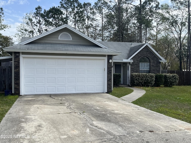 ranch-style home featuring a front yard, fence, concrete driveway, a garage, and brick siding