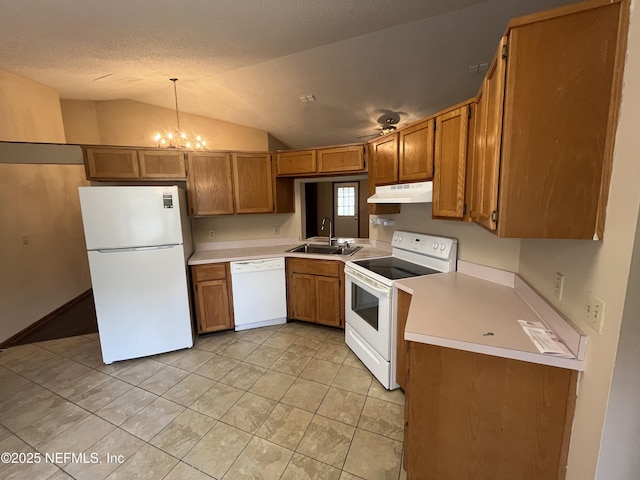 kitchen with white appliances, brown cabinetry, a sink, light countertops, and under cabinet range hood