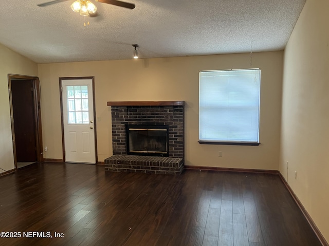 unfurnished living room featuring a fireplace, a textured ceiling, ceiling fan, and hardwood / wood-style flooring