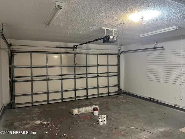 garage with a garage door opener and baseboards