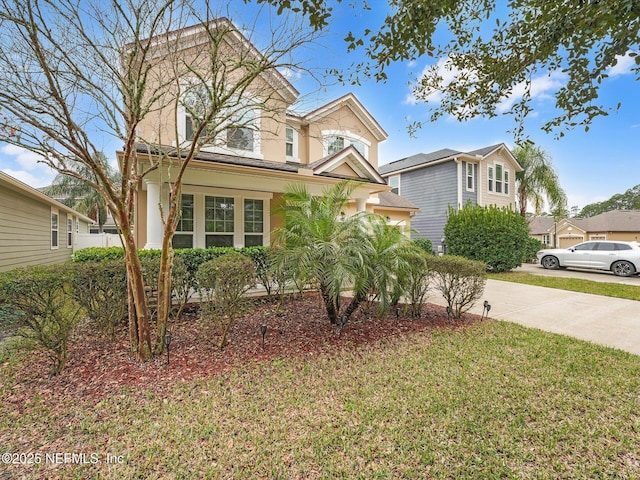 front of property with covered porch and a front lawn