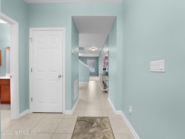 hallway featuring light tile patterned floors