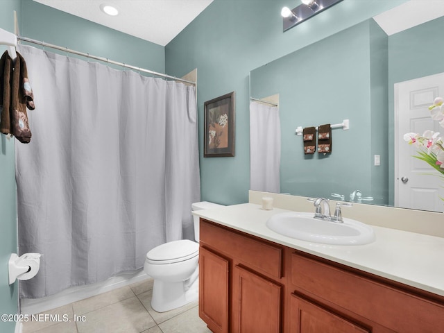 bathroom featuring vanity, tile patterned floors, and toilet