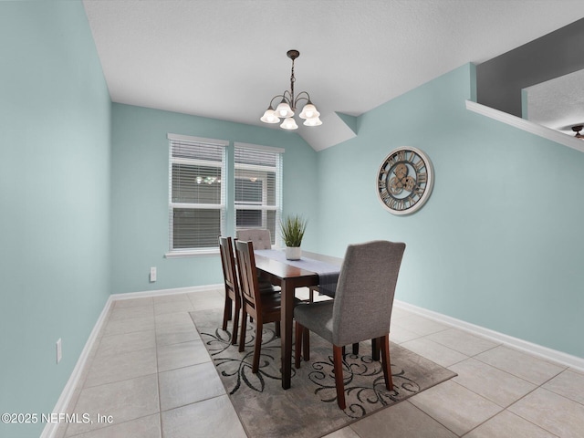 tiled dining area featuring an inviting chandelier, lofted ceiling, and a textured ceiling