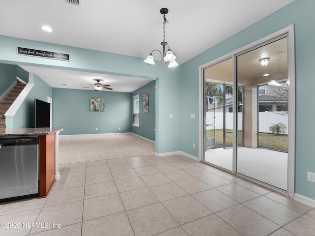 interior space featuring light tile patterned flooring and ceiling fan with notable chandelier