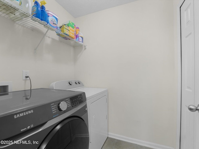 clothes washing area featuring separate washer and dryer and tile patterned flooring