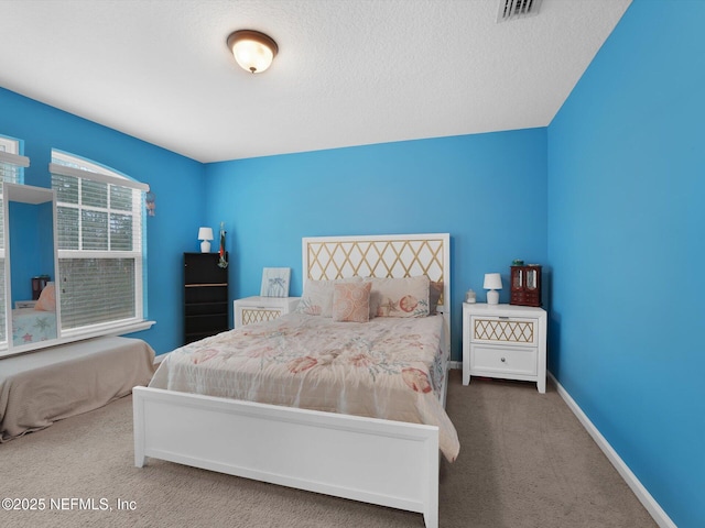 carpeted bedroom featuring a textured ceiling